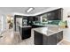 Modern kitchen featuring dark cabinets, stainless steel appliances, an island, and granite countertops at 8078 Longleaf Dr, Villa Rica, GA 30180