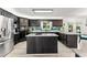 Spacious kitchen boasts black cabinetry, center island, stainless steel appliances, and granite countertops at 8078 Longleaf Dr, Villa Rica, GA 30180