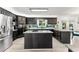 Modern kitchen featuring dark cabinets, stainless steel appliances, an island, and granite countertops at 8078 Longleaf Dr, Villa Rica, GA 30180