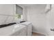 Clean and bright laundry room with white washer and dryer and shelving at 8078 Longleaf Dr, Villa Rica, GA 30180