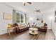 Spacious living room with hardwood floors, comfortable seating, and natural light from large windows at 8078 Longleaf Dr, Villa Rica, GA 30180