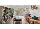 Bright living room featuring hardwood floors, large windows, and a stylish plant display at 8078 Longleaf Dr, Villa Rica, GA 30180