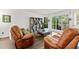 Cozy living room with hardwood floors, large windows, and comfortable seating at 8078 Longleaf Dr, Villa Rica, GA 30180