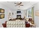 Inviting living room with a fireplace, ceiling fan, and large windows for natural light at 8078 Longleaf Dr, Villa Rica, GA 30180