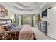 Main bedroom boasts tray ceilings, large windows with views, and a connecting bathroom at 8078 Longleaf Dr, Villa Rica, GA 30180