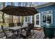 Outdoor patio featuring a dining area, grill, and views of the surrounding trees at 1514 Gilstrap Nw Ln, Atlanta, GA 30318