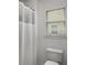 Bathroom featuring a toilet, shower and window offering plenty of natural light at 1514 Gilstrap Nw Ln, Atlanta, GA 30318