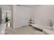 Cozy Bedroom with light pink walls, white crib, and comfortable armchair at 1514 Gilstrap Nw Ln, Atlanta, GA 30318