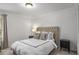 Bedroom featuring a bed with a white duvet cover, two side tables and soft carpeting at 1514 Gilstrap Nw Ln, Atlanta, GA 30318