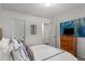 Bedroom with a bed featuring an upholstered headboard, wood dresser and modern art at 1514 Gilstrap Nw Ln, Atlanta, GA 30318