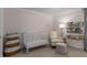 Bedroom area featuring a crib, a reading chair and storage for books at 1514 Gilstrap Nw Ln, Atlanta, GA 30318