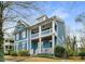 Charming two-story home featuring a double porch, blue siding, and manicured landscaping at 1514 Gilstrap Nw Ln, Atlanta, GA 30318