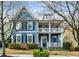 Beautiful two-story home with double porches, blue siding, and a well-maintained front yard at 1514 Gilstrap Nw Ln, Atlanta, GA 30318