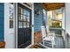 Inviting front porch featuring rocking chairs, brick accents, and a stylish front door at 1514 Gilstrap Nw Ln, Atlanta, GA 30318