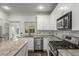 Modern kitchen featuring an island, stainless steel appliances, and tile backsplash at 1514 Gilstrap Nw Ln, Atlanta, GA 30318