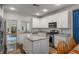 Well-lit kitchen boasting white cabinetry, stainless steel appliances, granite countertops, and adjacent breakfast nook at 1514 Gilstrap Nw Ln, Atlanta, GA 30318