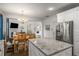 Open-concept kitchen with stainless steel appliances and a large island, connecting to the dining and living areas at 1514 Gilstrap Nw Ln, Atlanta, GA 30318