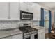 Well-equipped kitchen with stainless steel appliances, subway tile backsplash, and granite countertops at 1514 Gilstrap Nw Ln, Atlanta, GA 30318