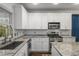 Bright kitchen features white cabinets, granite countertops, stainless appliances, and subway tile backsplash at 1514 Gilstrap Nw Ln, Atlanta, GA 30318