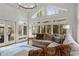 Bright sunroom with vaulted ceilings, many windows, and a cozy seating area with access to a deck at 1514 Gilstrap Nw Ln, Atlanta, GA 30318