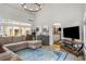 Spacious living area with many windows, large sectional couch and adjacent bar with tv at 1514 Gilstrap Nw Ln, Atlanta, GA 30318