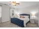 Cozy bedroom with elegant, tufted headboard, ample natural light, and plush carpeting at 1514 Gilstrap Nw Ln, Atlanta, GA 30318