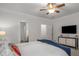 Comfortable primary bedroom with plush carpet, television, and ensuite bathroom at 1514 Gilstrap Nw Ln, Atlanta, GA 30318