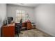 Office area with a dark stained desk, computer equipment and an area rug at 1514 Gilstrap Nw Ln, Atlanta, GA 30318