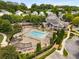Aerial view of a community pool with lounge chairs, a clubhouse, and lush landscaping at 1514 Gilstrap Nw Ln, Atlanta, GA 30318