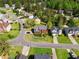 Residential street featuring colorful homes surrounded by mature trees, expansive lawns, and neatly landscaped yards at 1710 Brandon Lee Sw Way, Marietta, GA 30008
