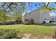 Large backyard with lush lawn, mature trees, shed, and two-story home at 1710 Brandon Lee Sw Way, Marietta, GA 30008