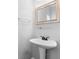 Elegant bathroom with a pedestal sink, gold mirror and modern fixtures at 1710 Brandon Lee Sw Way, Marietta, GA 30008