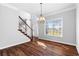 Elegant dining area featuring hardwood floors, chandelier, and a staircase at 1710 Brandon Lee Sw Way, Marietta, GA 30008