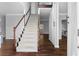 Inviting foyer with hardwood floors, a staircase, and an open view into other rooms at 1710 Brandon Lee Sw Way, Marietta, GA 30008