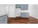 The kitchen features updated blue cabinets and modern flooring in an open layout at 1710 Brandon Lee Sw Way, Marietta, GA 30008
