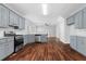 Modern kitchen featuring stainless steel appliances, hardwood floors, and a view into the living room at 1710 Brandon Lee Sw Way, Marietta, GA 30008