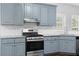 Kitchen showcasing stainless steel range, granite countertops, updated cabinets, and tile backsplash at 1710 Brandon Lee Sw Way, Marietta, GA 30008