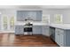 Modern kitchen featuring stainless steel appliances, granite countertops, and updated blue cabinets at 1710 Brandon Lee Sw Way, Marietta, GA 30008