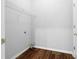 A simple Laundry Room with hard wood floors, shelving and utility hookups at 1710 Brandon Lee Sw Way, Marietta, GA 30008