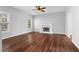 Spacious living room featuring hardwood floors, a ceiling fan, and a fireplace at 1710 Brandon Lee Sw Way, Marietta, GA 30008
