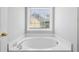 Close up of a tub with chrome hardware and a view out the window at 1710 Brandon Lee Sw Way, Marietta, GA 30008