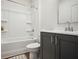 Clean bathroom featuring a shower-tub combination and a gray vanity with a modern faucet and fixtures at 203 Color Cir, Atlanta, GA 30317