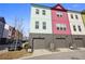 Townhome exterior showcasing vibrant colors, garage doors, and well-maintained landscaping at 203 Color Cir, Atlanta, GA 30317