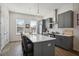 Modern kitchen with sleek gray cabinetry, a quartz island with seating, and stainless steel appliances at 203 Color Cir, Atlanta, GA 30317