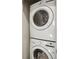 Efficient laundry closet featuring a stacked washer and dryer for convenient laundry access at 203 Color Cir, Atlanta, GA 30317
