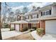 Attractive townhome showcasing a brick facade, attached garages, manicured landscaping, and convenient parking at 44 Hall Mnr, Alpharetta, GA 30022