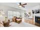 Cozy living room boasts a fireplace, hardwood floors, comfortable seating, and an adjacent office space at 44 Hall Mnr, Alpharetta, GA 30022
