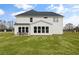 Spacious backyard with an outdoor dining setup and large windows on the house at 5310 Julep Ct, Cumming, GA 30028