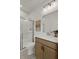 Modern bathroom featuring a glass-enclosed shower, wood vanity, and neutral color palette at 5310 Julep Ct, Cumming, GA 30028