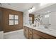 Bathroom with double vanity, white countertop, framed mirrors and glass shower at 5310 Julep Ct, Cumming, GA 30028